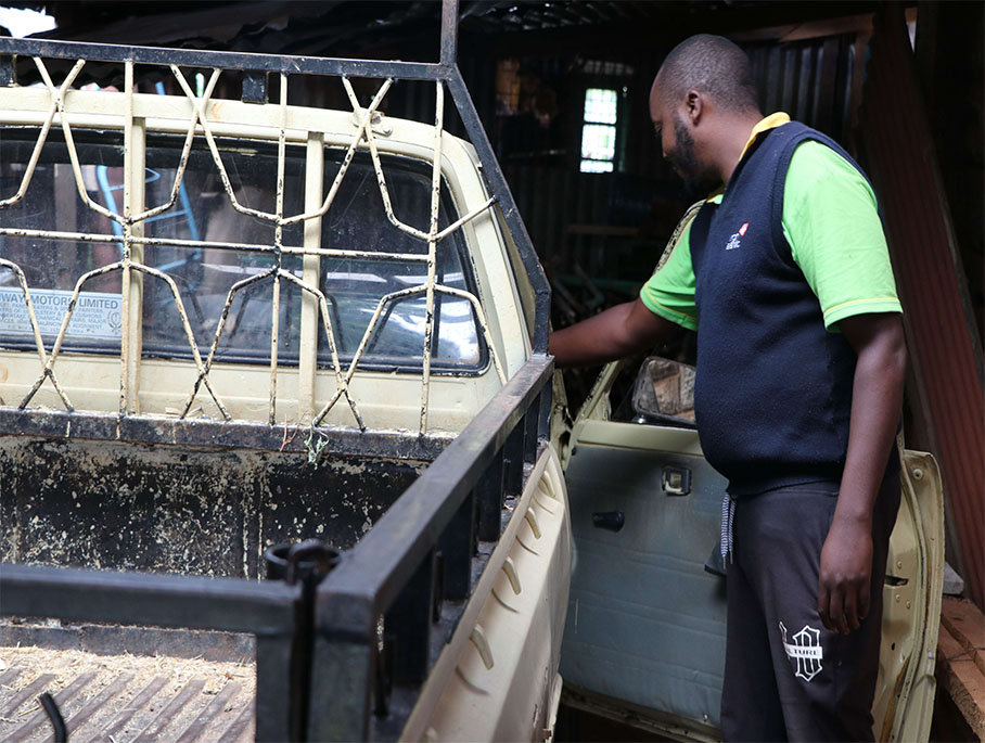 Leonard opens a door to his newly acquired pick-up for his farm errands